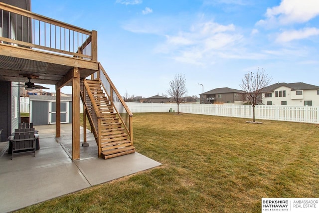 view of yard featuring a patio, a deck, ceiling fan, and a shed