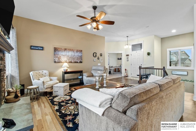 living room featuring ceiling fan and light wood-type flooring