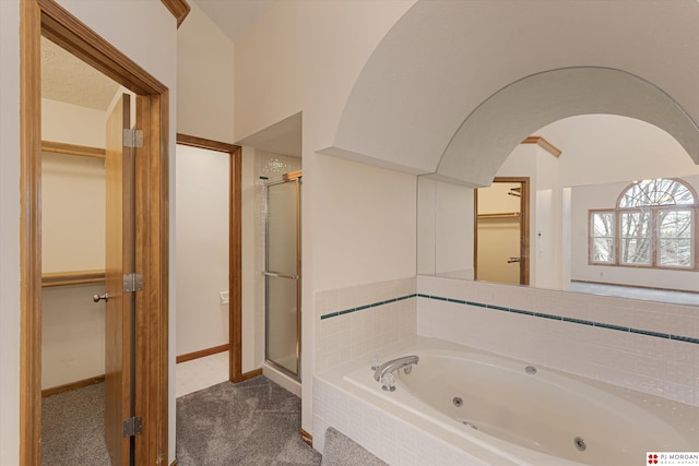 bathroom featuring separate shower and tub