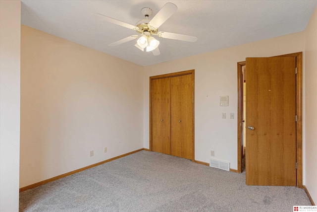 empty room with ceiling fan and light carpet