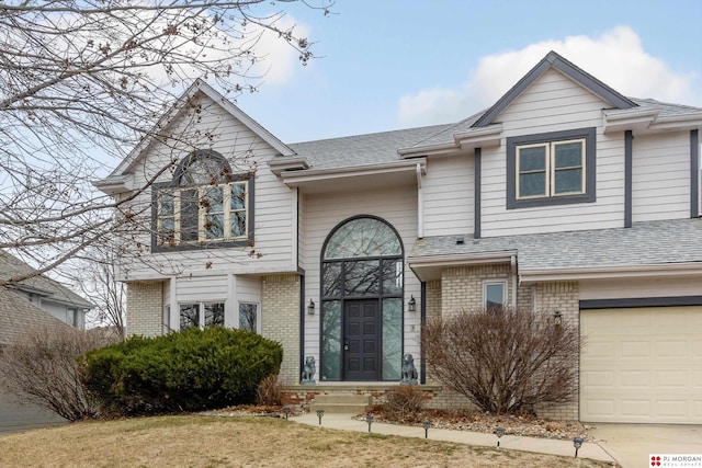 view of front of property featuring a front yard and a garage