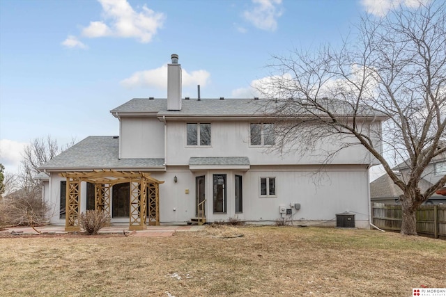 rear view of house with a pergola and a yard