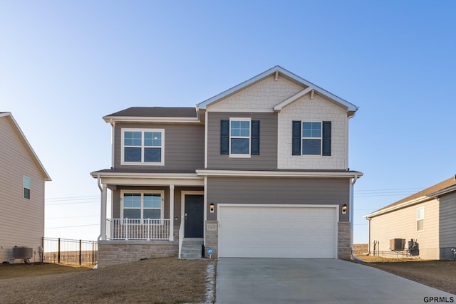 craftsman-style home featuring central AC, a porch, and a garage