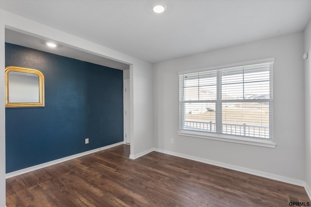 empty room with dark hardwood / wood-style flooring