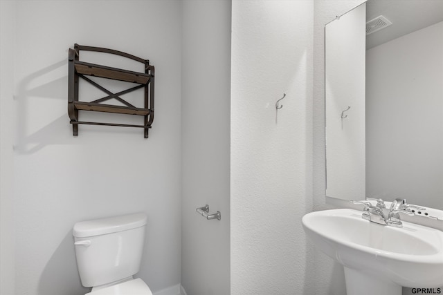 bathroom featuring sink and toilet