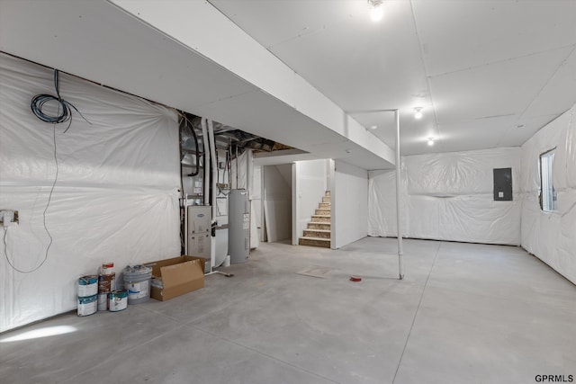 basement featuring electric water heater and electric panel