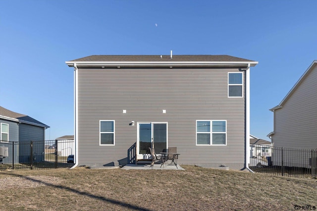 back of house featuring a yard and a patio