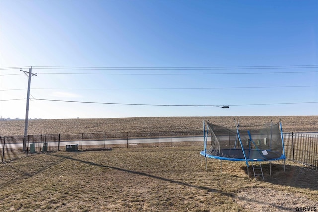 view of yard with a rural view and a trampoline