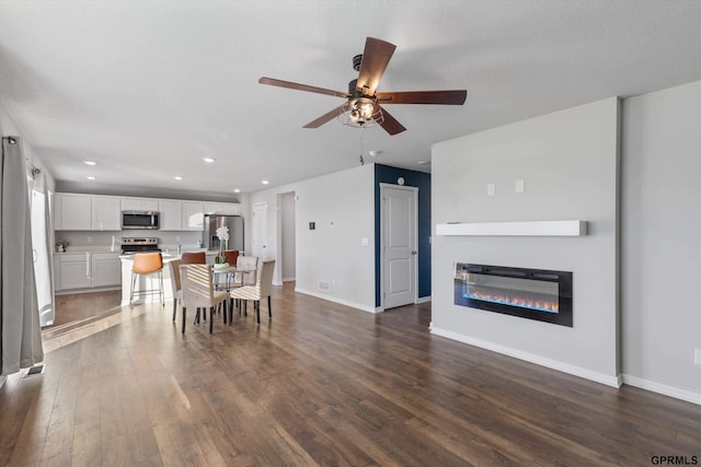 dining area featuring ceiling fan and dark wood-type flooring