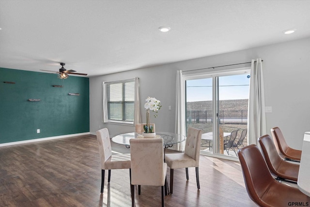 dining area featuring ceiling fan, a healthy amount of sunlight, and wood-type flooring