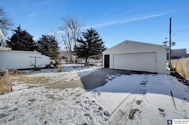 exterior space with a garage and an outbuilding