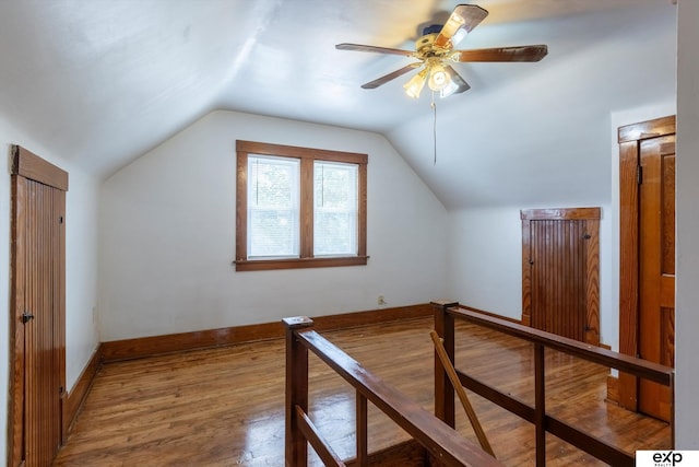 additional living space with wood-type flooring, ceiling fan, and lofted ceiling