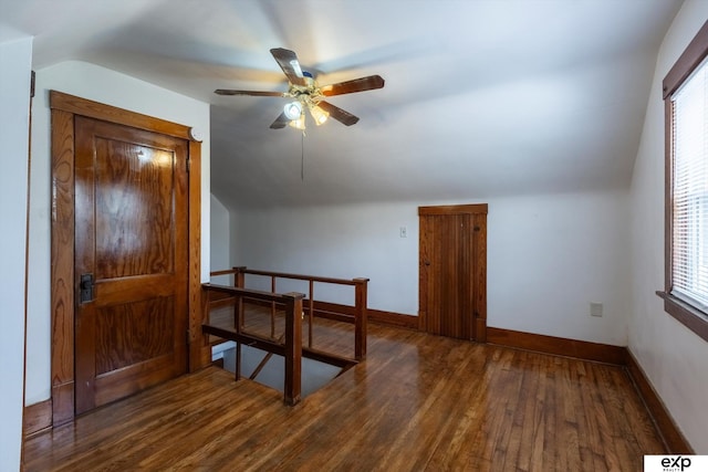 bonus room with vaulted ceiling, ceiling fan, and dark hardwood / wood-style floors