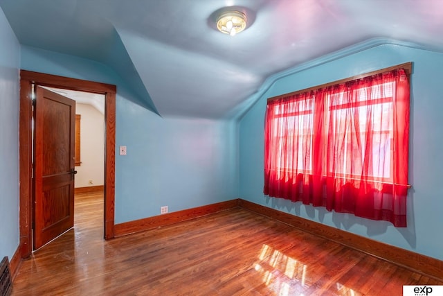 bonus room featuring lofted ceiling and hardwood / wood-style flooring