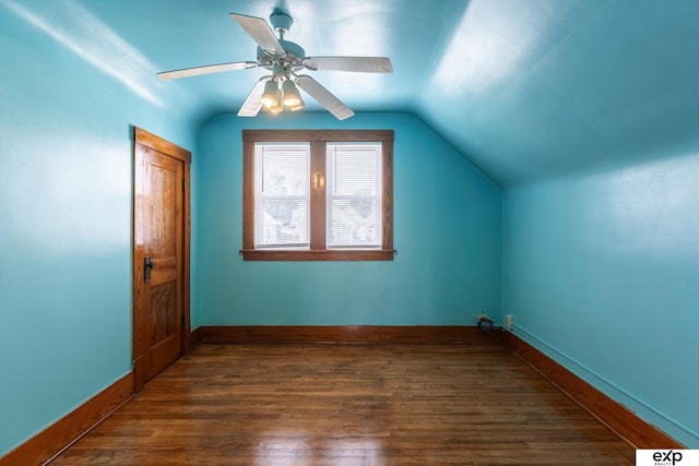 additional living space with dark hardwood / wood-style flooring, vaulted ceiling, and ceiling fan