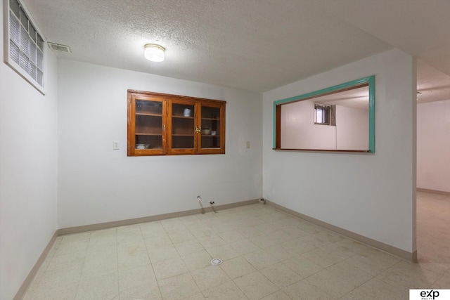 spare room featuring a textured ceiling