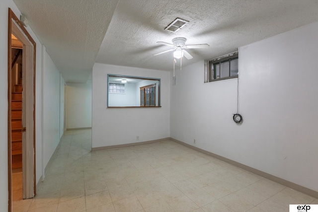 unfurnished room featuring a textured ceiling and ceiling fan