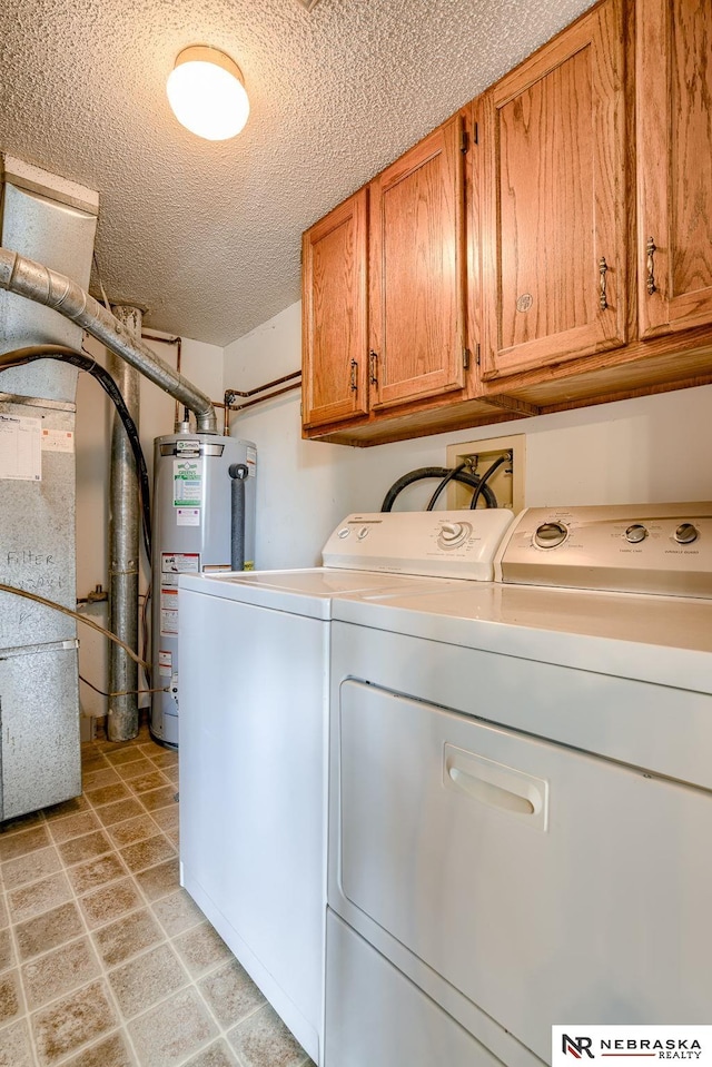 washroom with a textured ceiling, washer and clothes dryer, water heater, cabinets, and heating unit