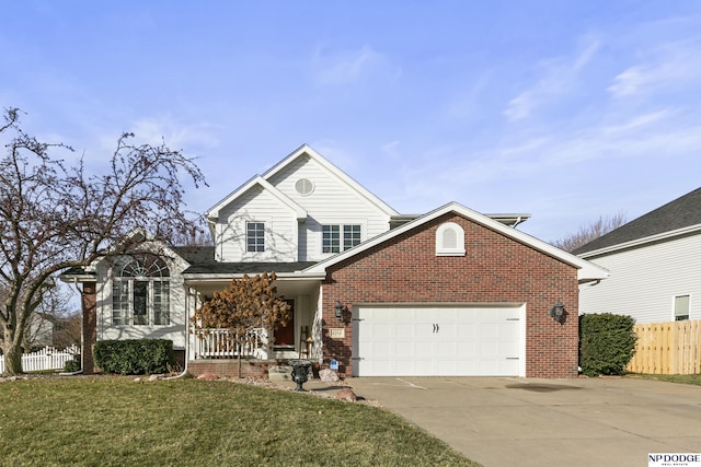 view of property with covered porch, a garage, and a front yard