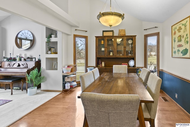 dining room with light wood-type flooring and a wealth of natural light