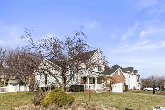 view of front of property with a front lawn, a porch, and a garage