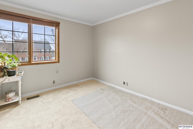 empty room featuring light colored carpet and ornamental molding