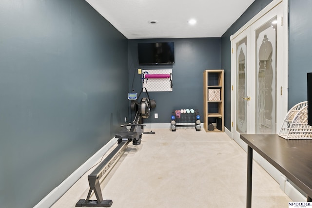 workout area featuring light colored carpet