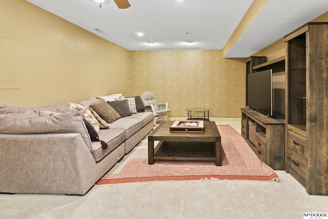 carpeted living room with ceiling fan