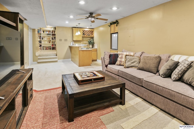 carpeted living room with ceiling fan