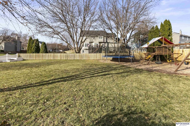 view of yard featuring a playground and a trampoline