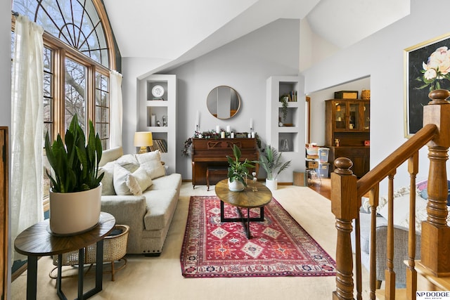 living room featuring vaulted ceiling and built in features