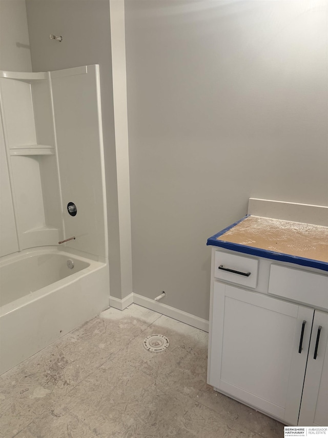 bathroom with baseboards and shower / tub combination