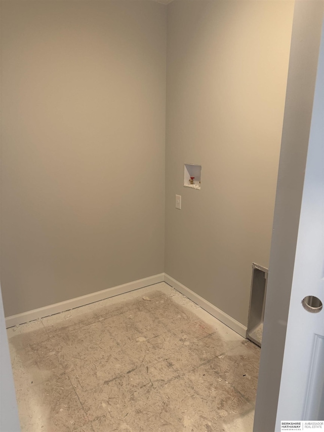 clothes washing area with washer hookup, baseboards, and laundry area