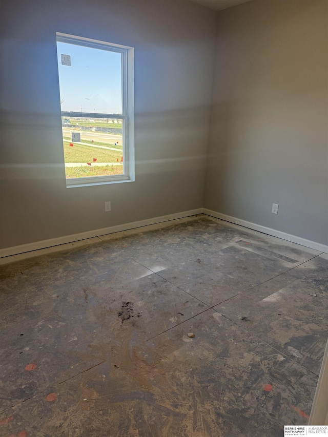 spare room featuring baseboards