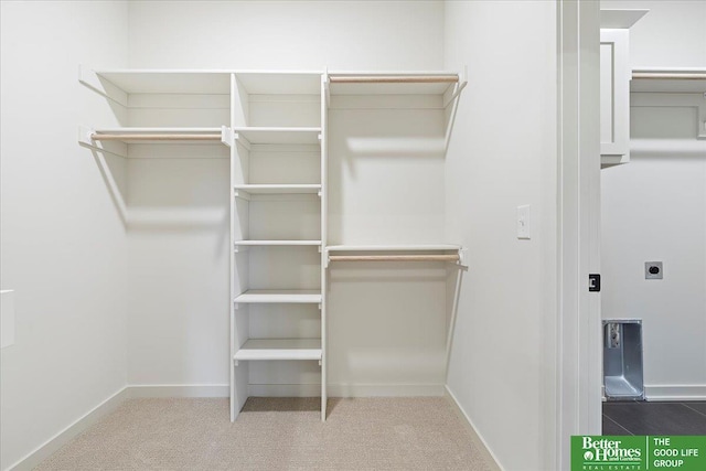 walk in closet with carpet floors