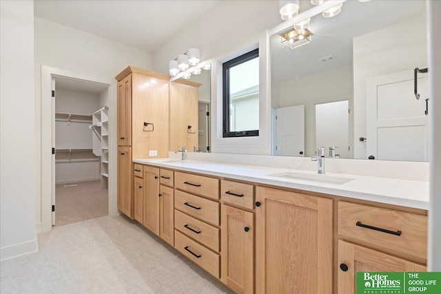 bathroom with visible vents, a sink, and double vanity