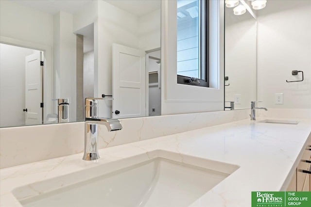 full bath with double vanity and a sink