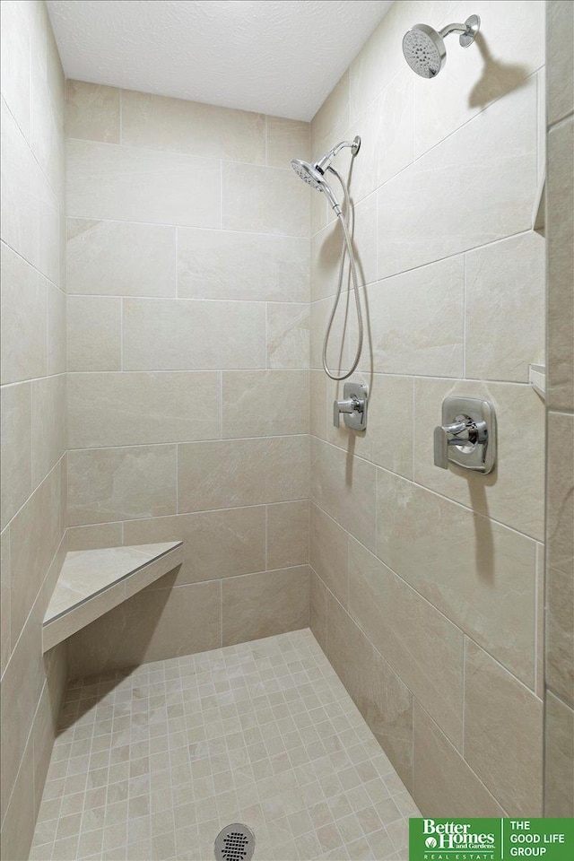 bathroom with tiled shower