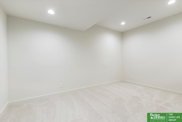 spare room featuring recessed lighting, visible vents, light carpet, and baseboards