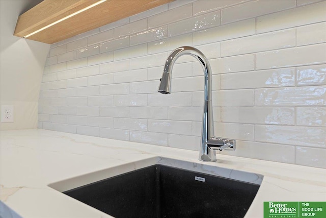 kitchen with light stone countertops and sink