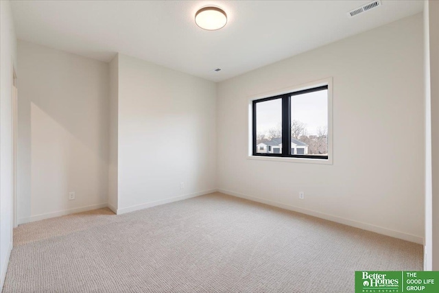 unfurnished room featuring light colored carpet, visible vents, and baseboards