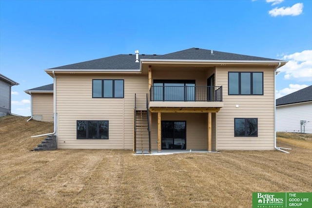 back of house with a lawn, a balcony, and a patio