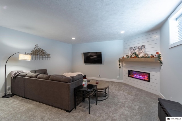 carpeted living room featuring a textured ceiling