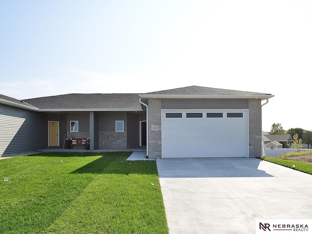 view of front of house with a front yard and a garage