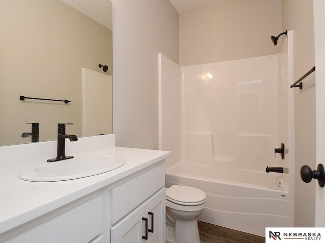 full bathroom with hardwood / wood-style flooring, vanity, toilet, and shower / tub combination