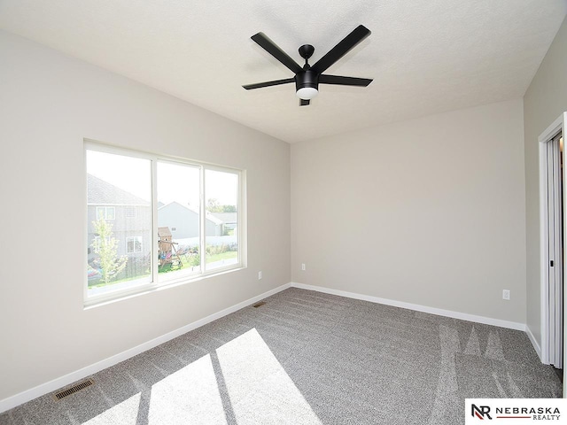 unfurnished bedroom featuring ceiling fan, carpet floors, and a textured ceiling