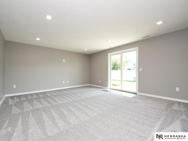 spare room featuring light carpet