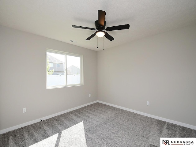 carpeted empty room featuring a textured ceiling and ceiling fan