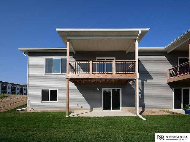 back of house with a lawn and a patio