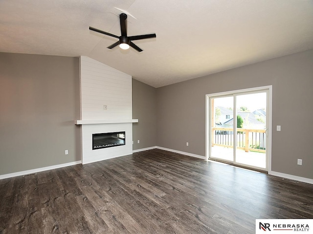 unfurnished living room featuring a fireplace, dark hardwood / wood-style floors, vaulted ceiling, and ceiling fan